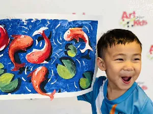 Kid showing a painting at an art class in Chiang Mai
